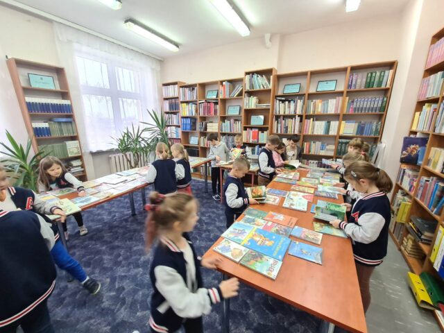Uczniowie klasy 1A w poszukiwaniu swoich pierwszych książek do wypożyczenia.