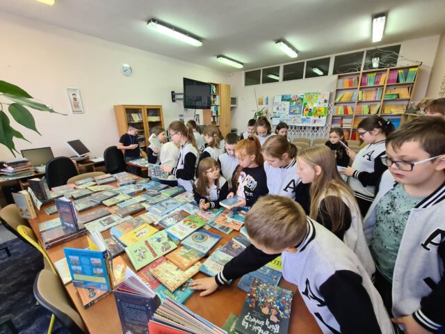 11-Uczniowie z klasy 4A wybierają książki do wypożyczenia, podczas wystawy nowości czytelniczych zakupionych w ramach Narodowego Programu Rozwoju Czytelnictwa.