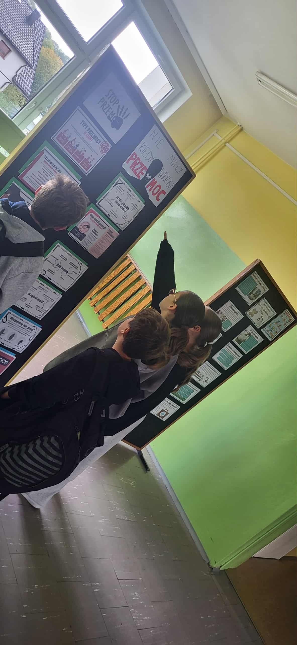 Zapoznawanie się z informacjami umieszczonymi na tablicach przez uczniów klas starszych.