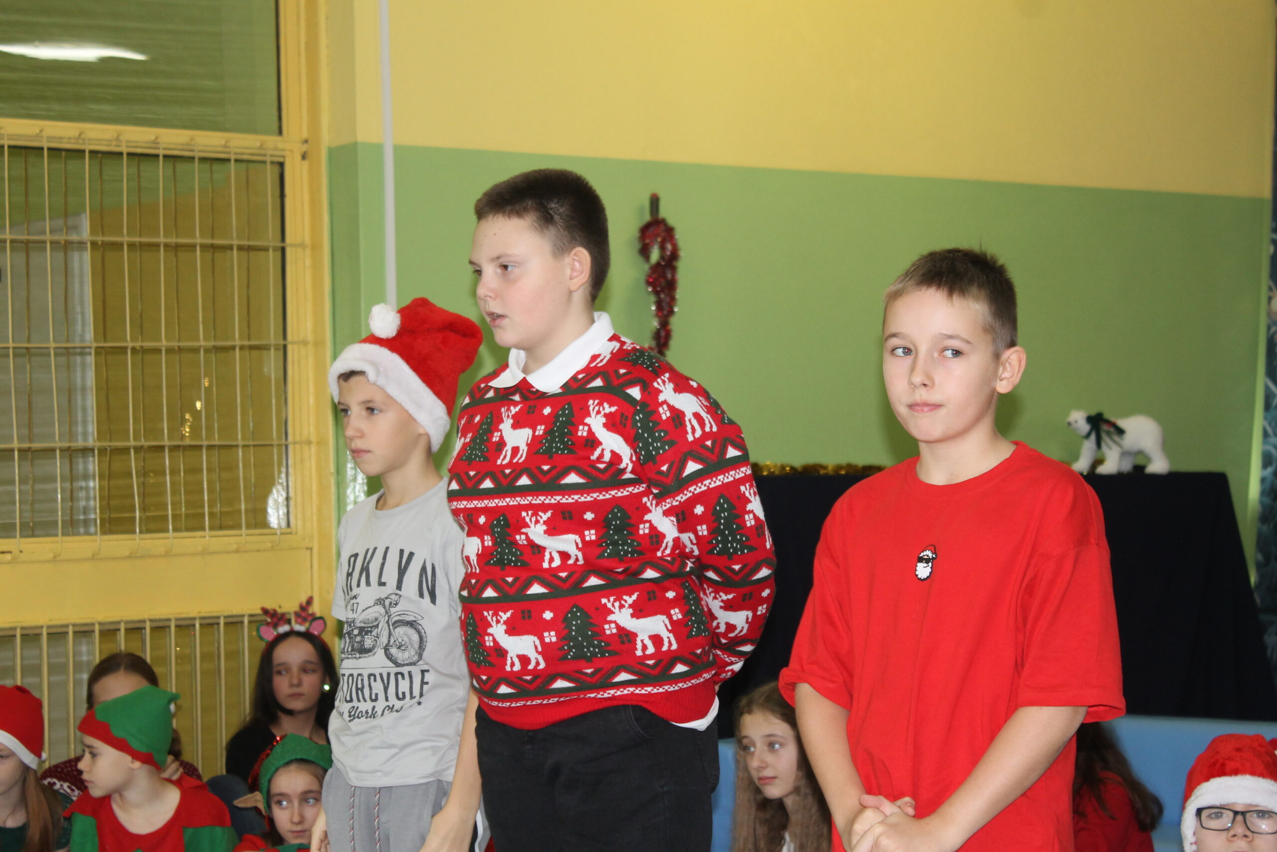 17 grudnia uczniowie klasy 4c zaprezentowali swoim koleżankom i kolegom z klas 1-8 przedstawienie pt. „Świąteczna zamiana miejsc”. Historia była pełna humoru, a jednocześnie niosła ważne przesłanie o empatii, życzliwości i wzajemnym zrozumieniu. Barwne stroje i zaangażowanie młodych aktorów zostały nagrodzone gromkimi brawami.